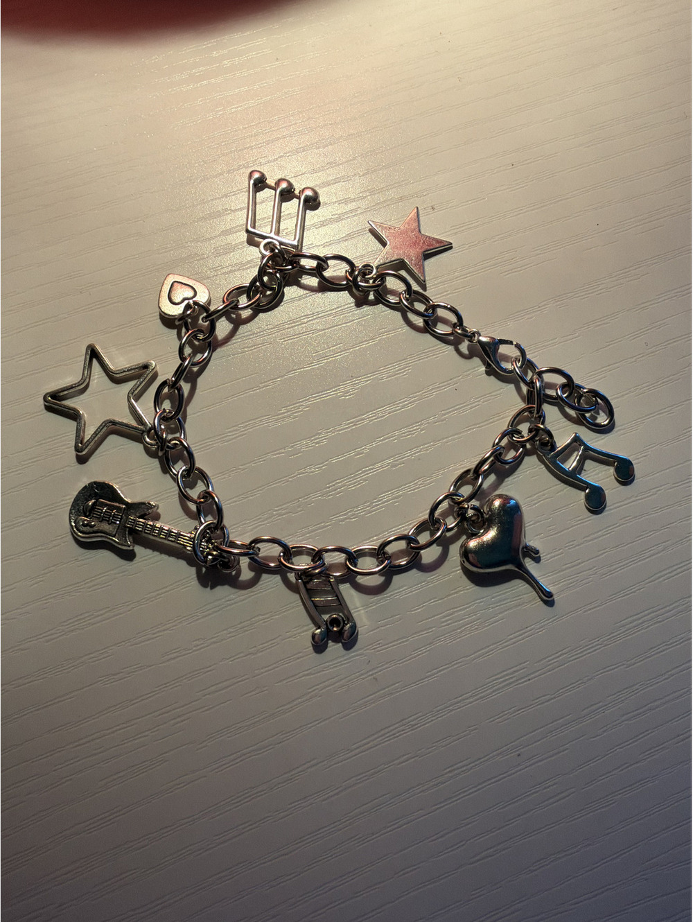 Music/rockstar themed charm bracelet with 8 charms.